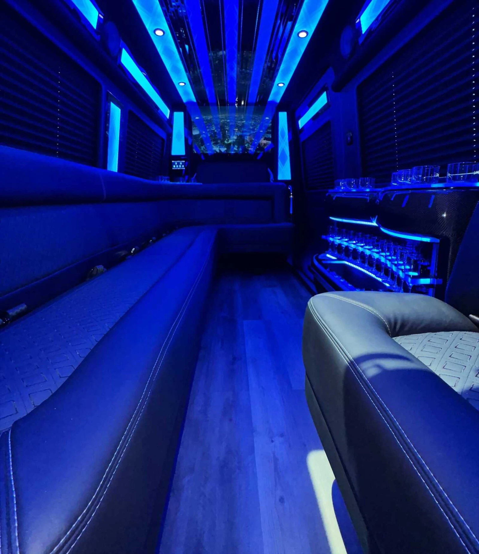 Sprinter Limo interior with blue LED lighting and facing bench seating - Royal Carriage Limousine Chicago