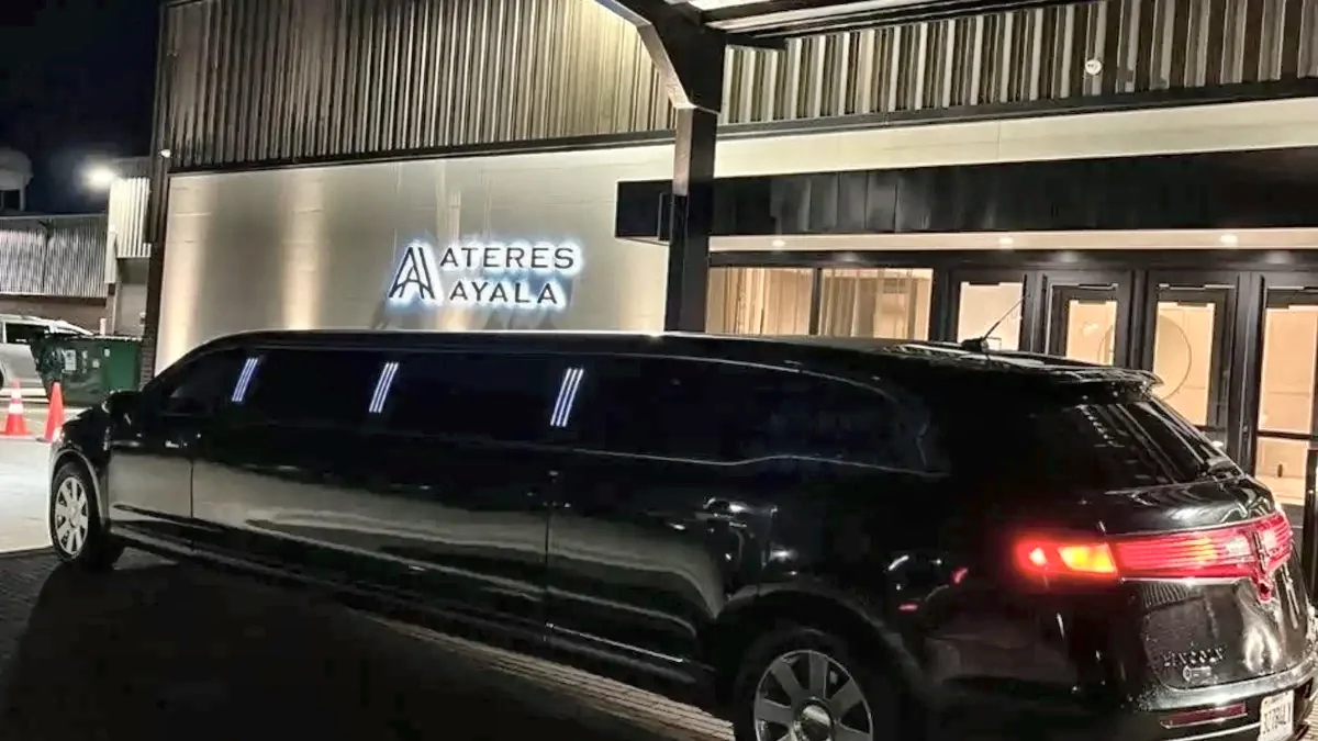 Black Lincoln MKT stretch limousine outside the Ateres Ayala event hall at night for Bat Mitzvah